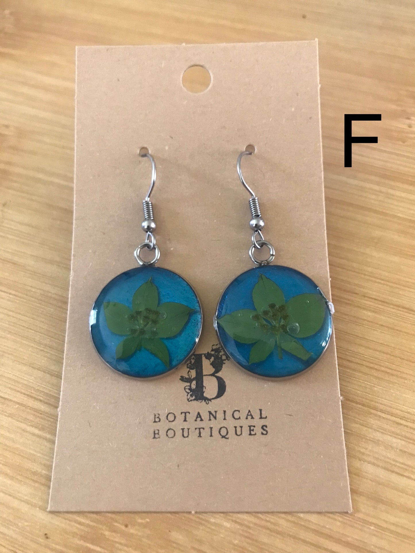Coloured background dangling earrings